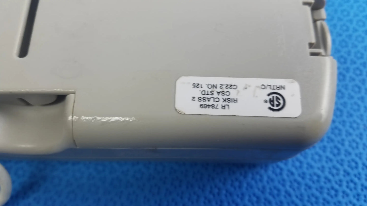 Gray plastic burdick oxy 100 pulse oximeter ref 92521 back with white label showing certification on medical equipment