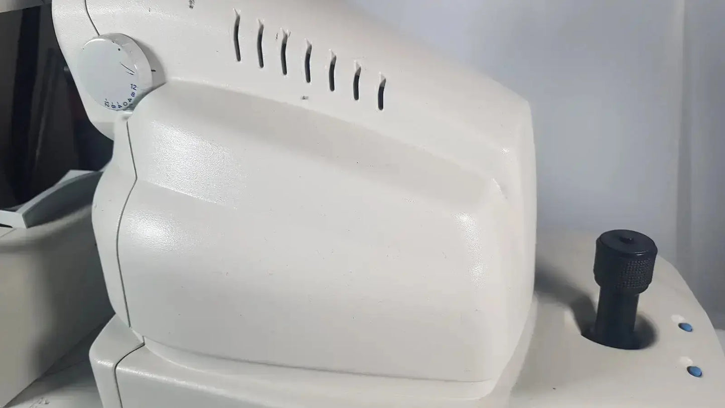 White plastic zeiss stratus oct patient module with circular dial and ventilation slits for direct cross-sectional imaging