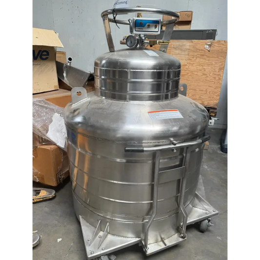 Stainless steel cryogenic tank with a blue and silver control panel, pressure gauge, and safety valves mounted on top.