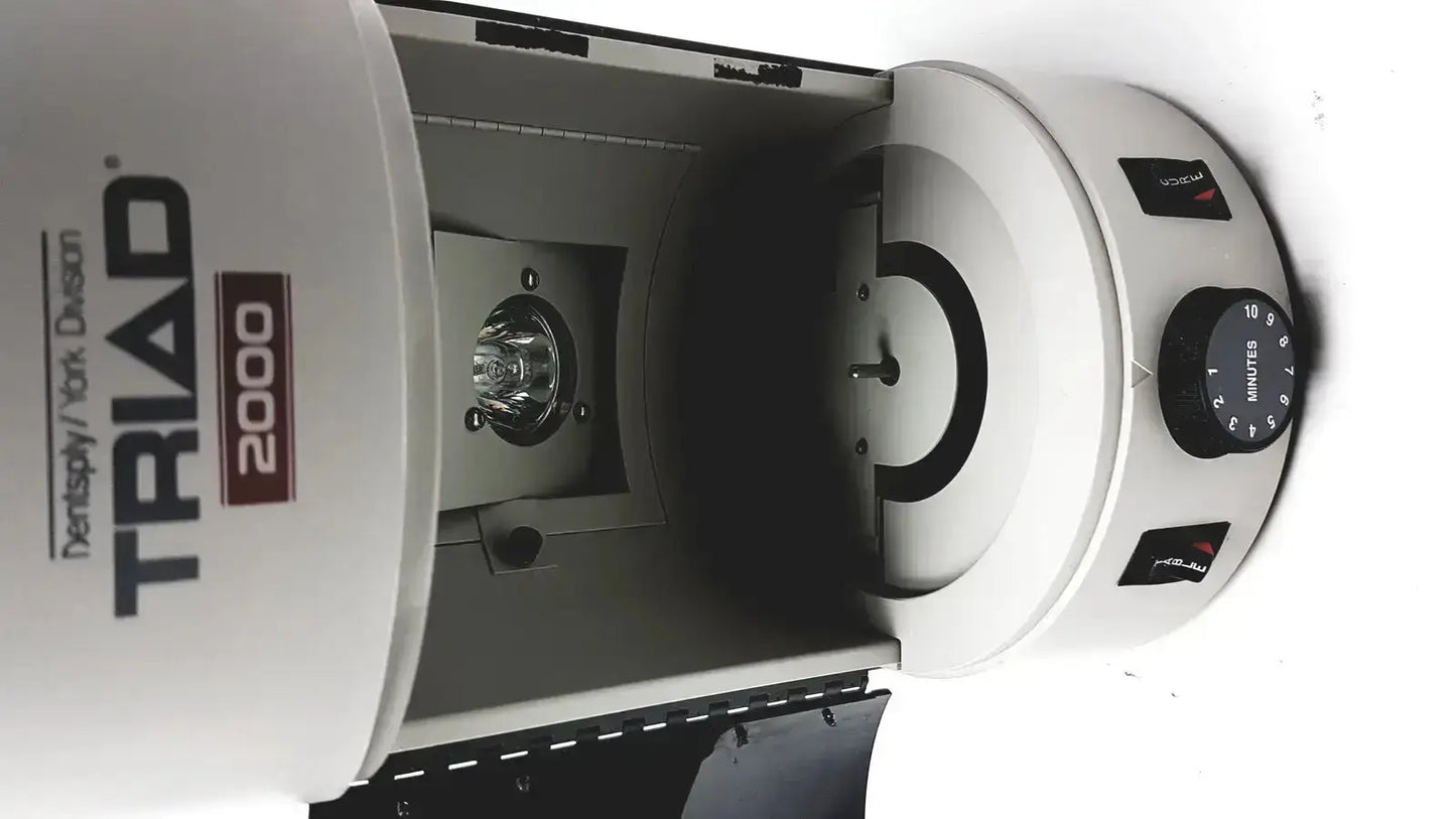White dentsply triad 2000 visible light cure system with circular chamber and control dial for dental curing