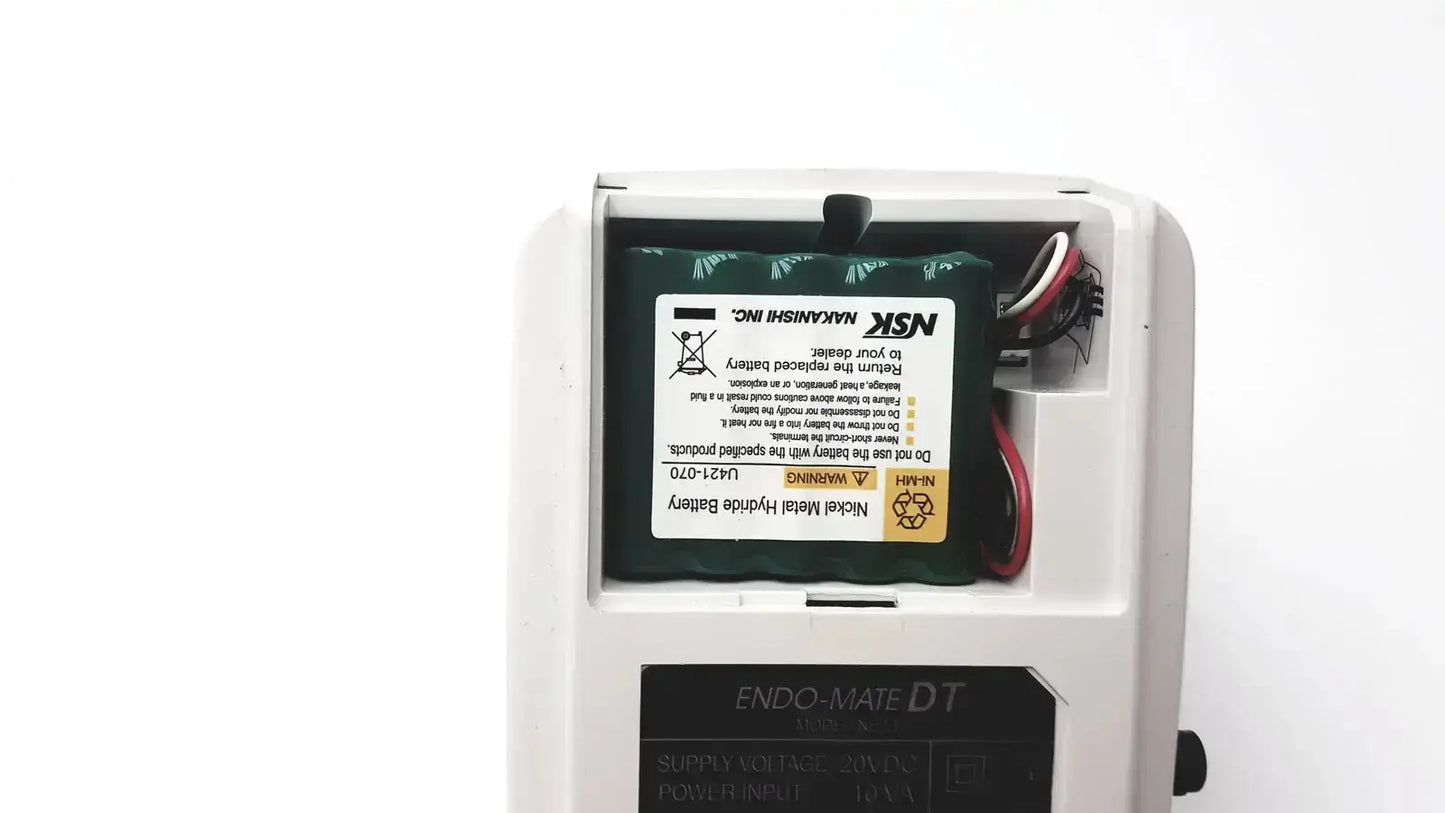 White plastic housing with green nsk nickel metal hydride battery and wires in endodontic micromotor used medical equipment for sale