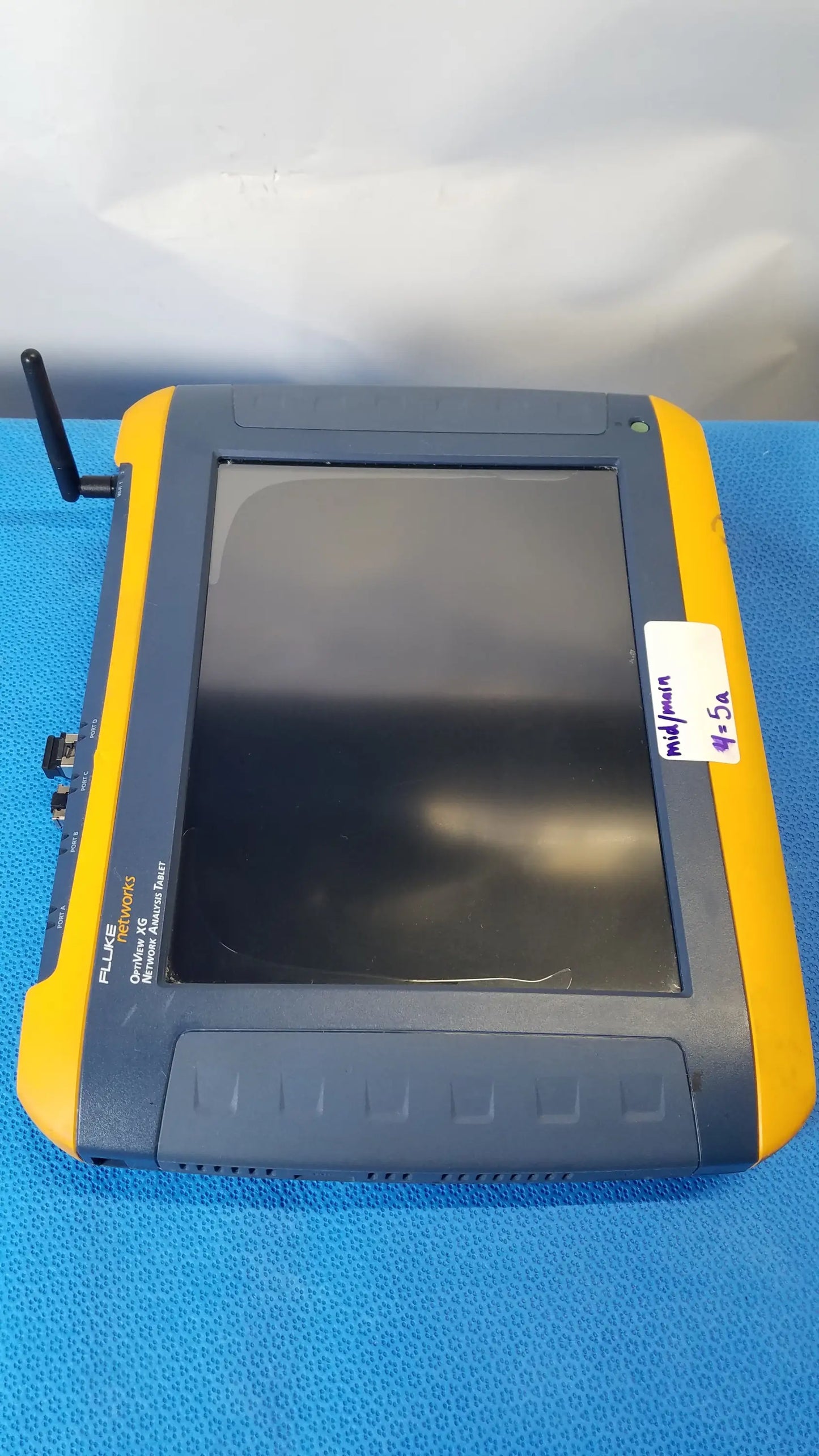 Yellow and gray fluke networks optiview xg network analysis tablet handheld device with black screen and top left antenna
