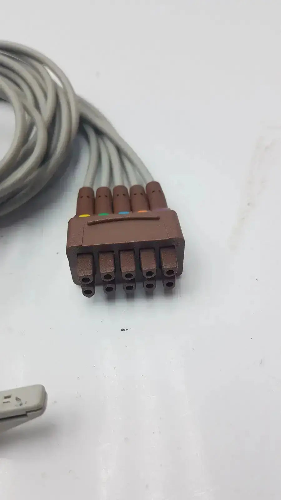 Brown plastic medical cable connector with six colored pins for ge multi-link ecg leadwire 5-lead v2-6 grabber