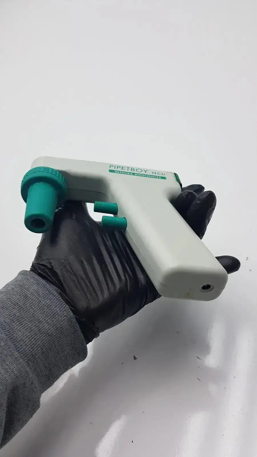 Integra Biosciences acu pipetboy controller in white with teal ergonomic grip for precise pipetting tasks