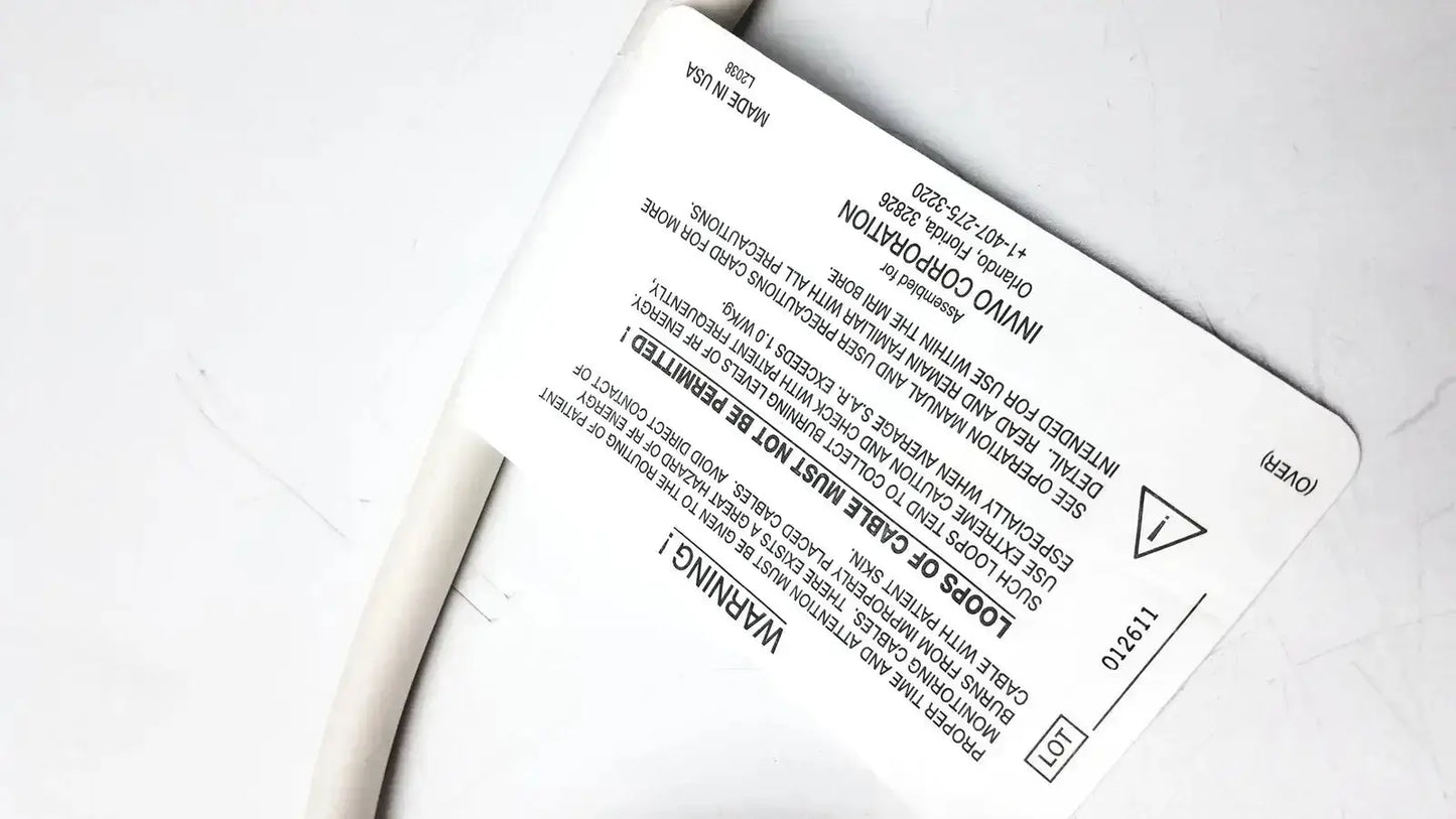 White rectangular label with black text and warning symbol on back of Invivo 9240A MRI ECG lead wires cable
