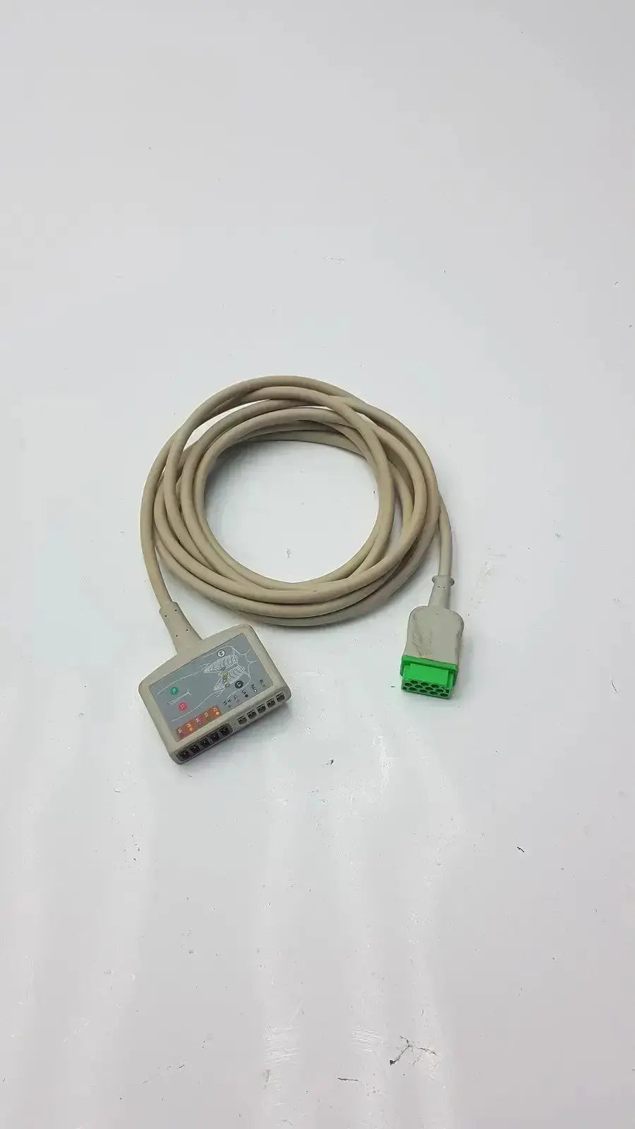 Beige multi-link ecg ttrunk cable by ge with gray connector housing and green plug for medical use