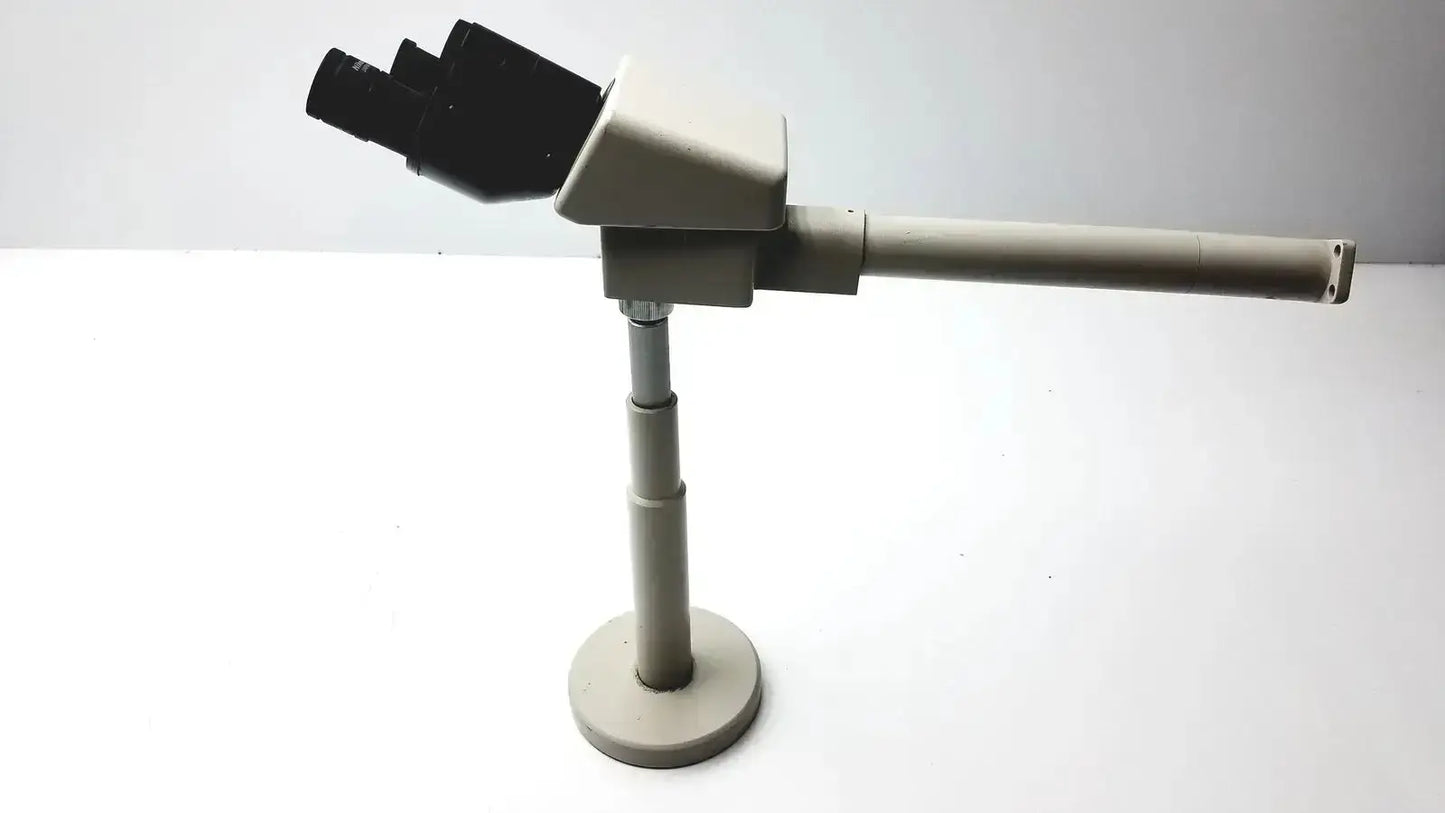 Beige Nikon 030039 binocular microscope with black objective lenses and telescoping arm for buy used medical equipment