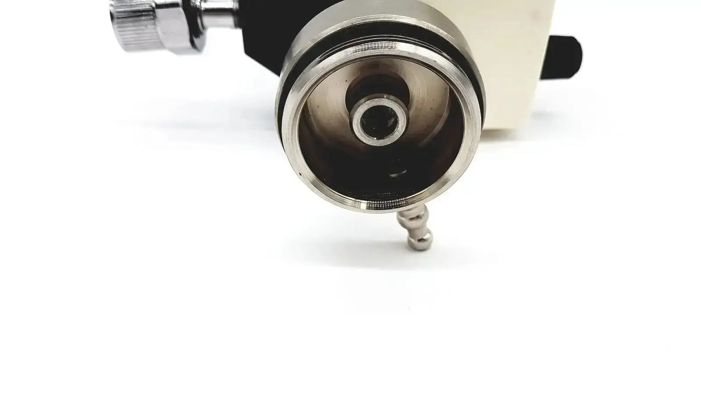 Chrome finished metal lens mount with black and cream housing on ohmeda ffa19643 intermittent unit front side
