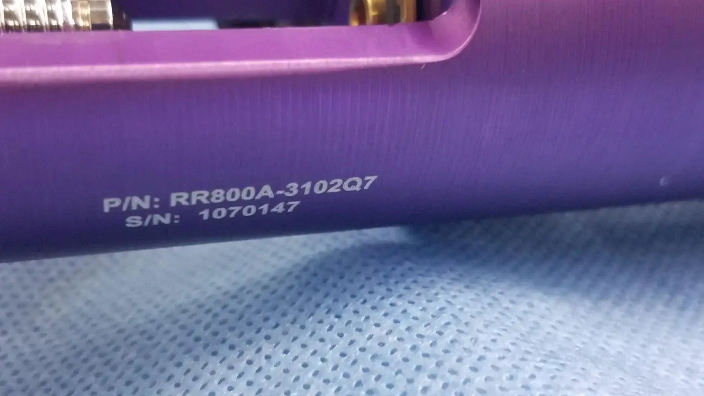 Purple cylindrical oxygen regulator with engraved part and serial numbers for precise medical gas flow control