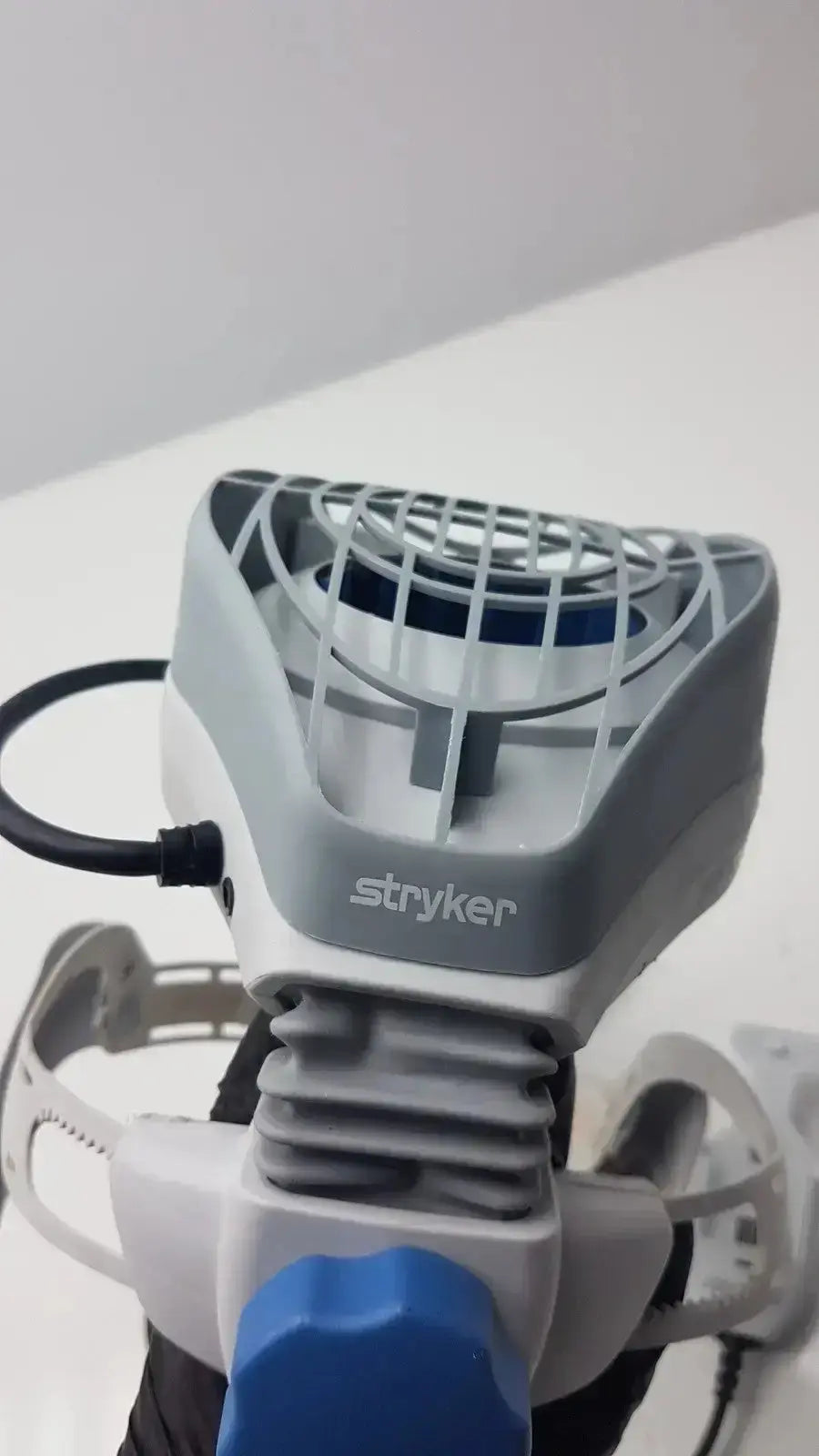 Gray and blue stryker flyte helmet ref ventilated grille and adjustable components for medical use