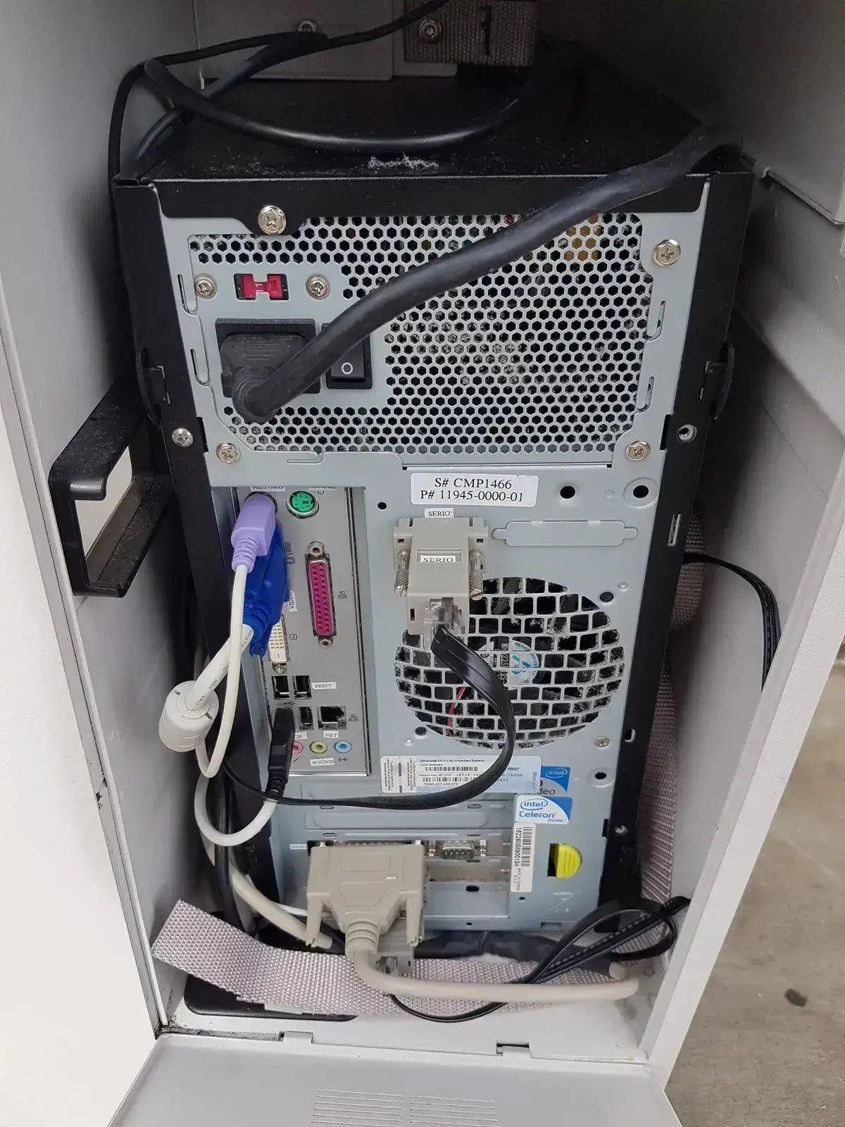 Back view of black and silver desktop computer tower with perforated metal panel and connected ports on multilab series ii lhs vascular cart