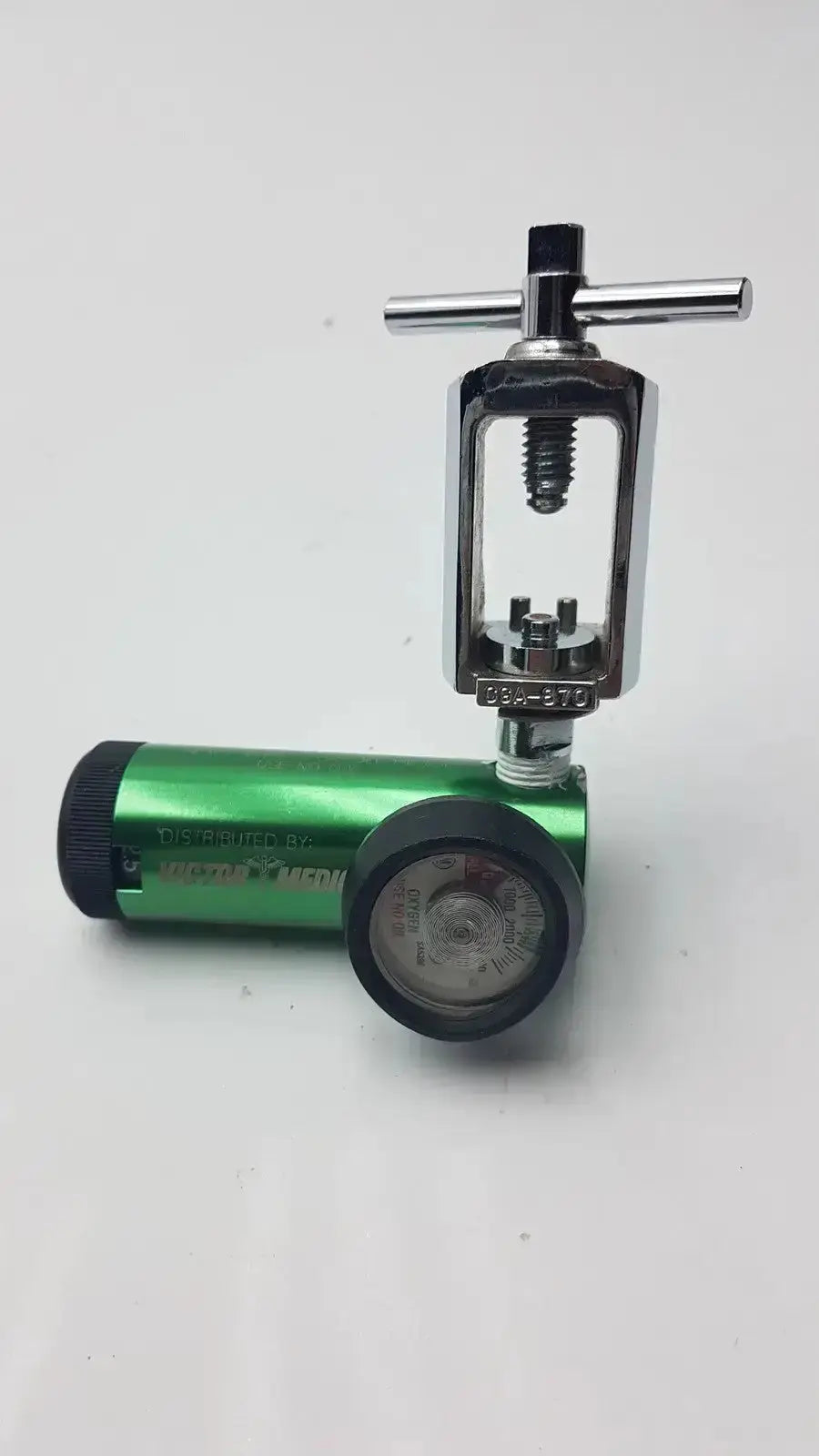 Green cylindrical victor medical air pressure regulator with chrome pressure gauge and valve assembly model FS II 8Y