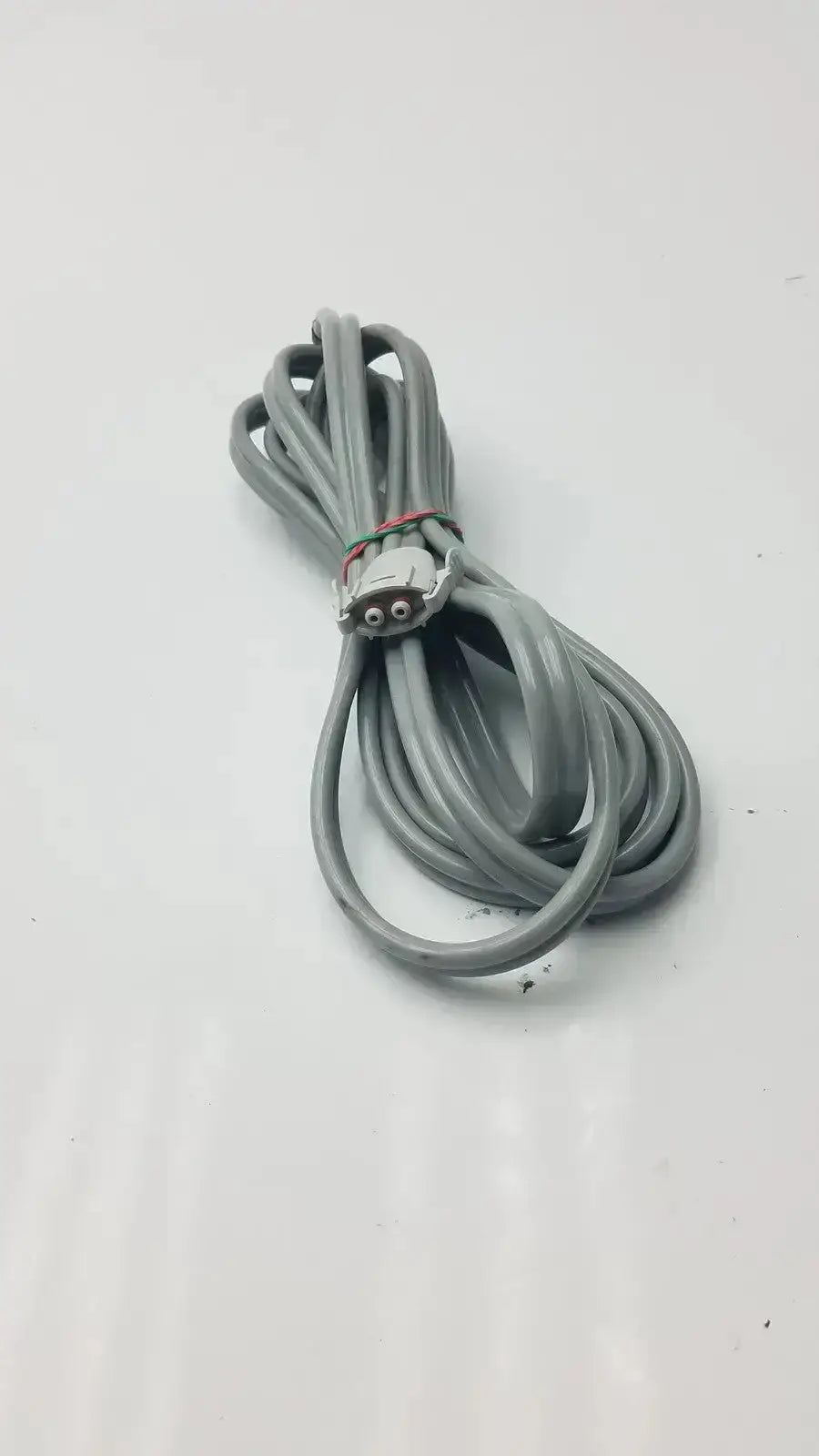 Gray coiled welch allyn blood pressure hose with locking connector and metallic end for medical use