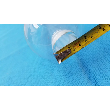 Clear plastic bottle with a metallic silver cap and measurement markings on its side.