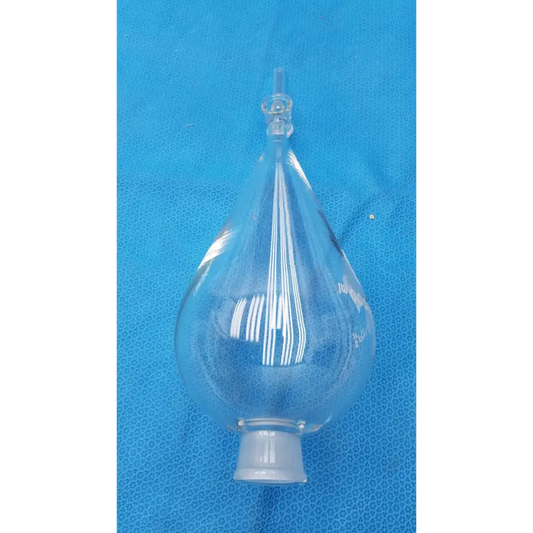 Clear glass distillation head with a bulbous lower section, narrow neck, and threaded base.
