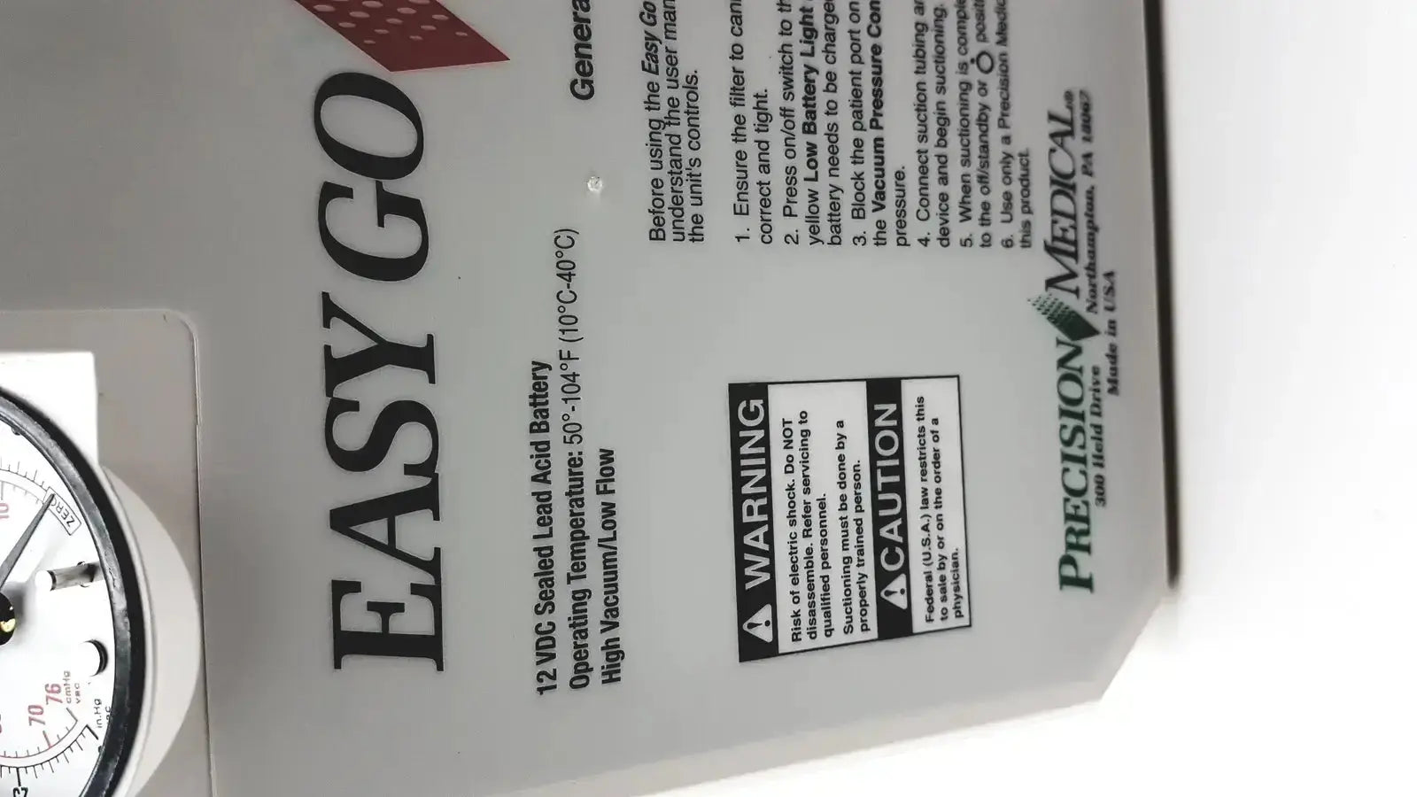 White plastic 2011 precision medical easy go vac aspirator back with black text and 12 vdc battery specs label