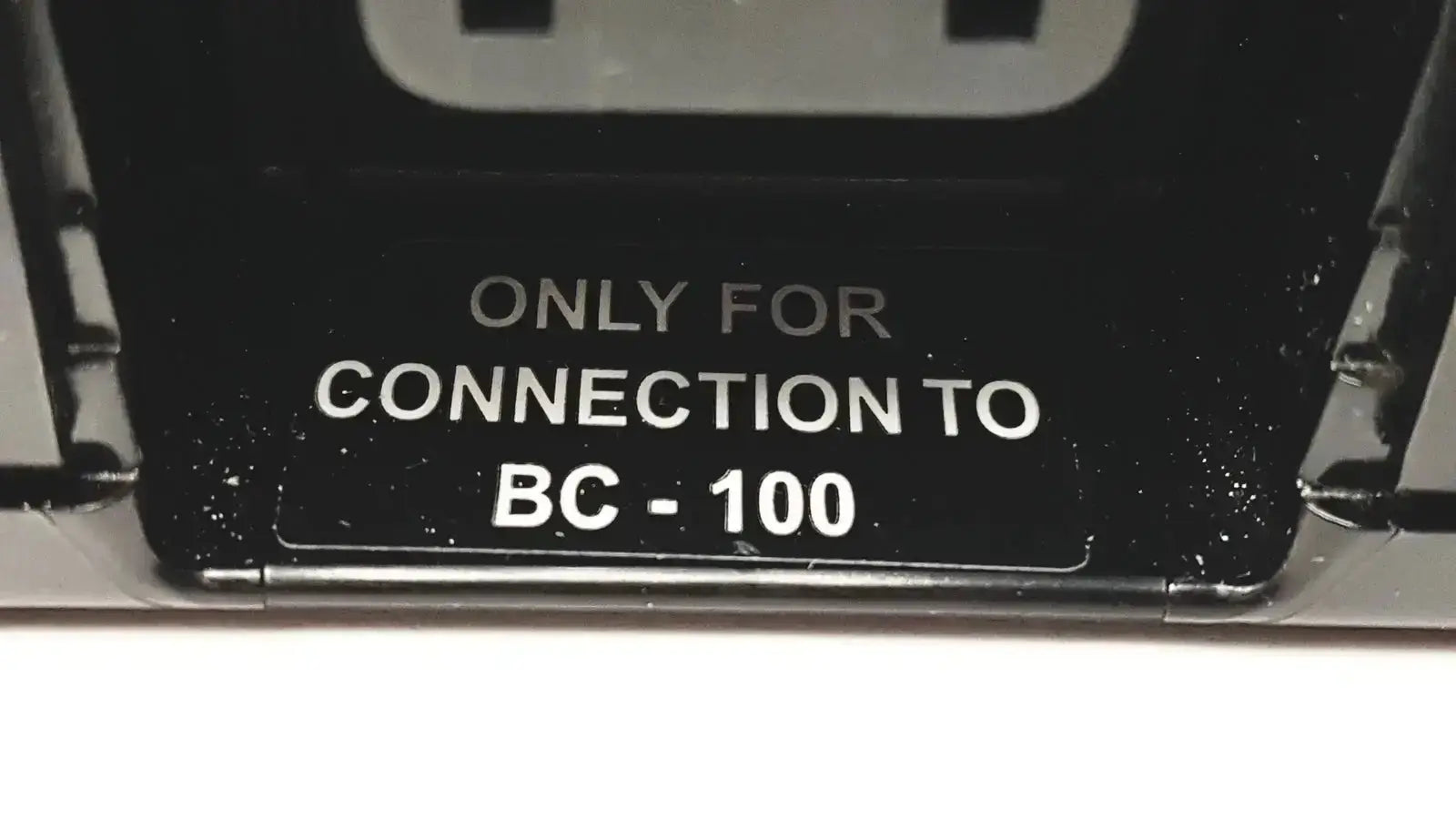 Black plastic label on the back of 3M bc-100 smart battery charger power base bc-210 for connection only