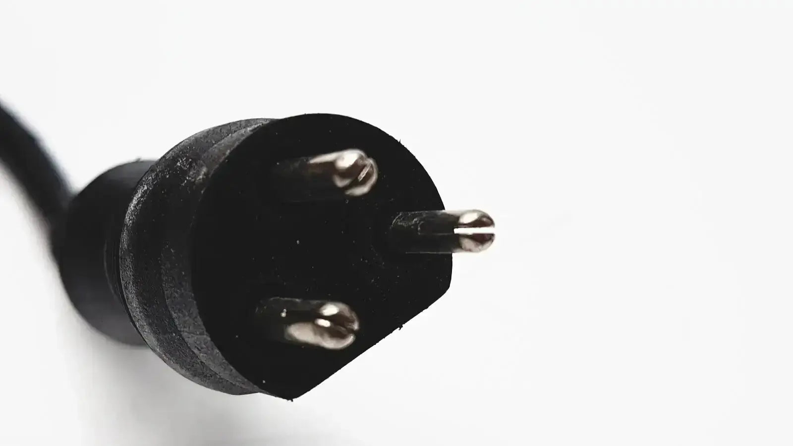 Black three-prong electrical plug with metallic contacts on the back of 3m bc-100 smart battery charger power base bc-210