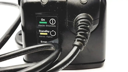 Black plastic 3M BC-100 smart battery charger power base with coiled cord and on standby error indicator lights