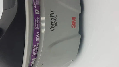 Gray 3m versaflo tr-300n+ respirator mask with purple labeling and black filter cartridge for tr-301n+ blower system