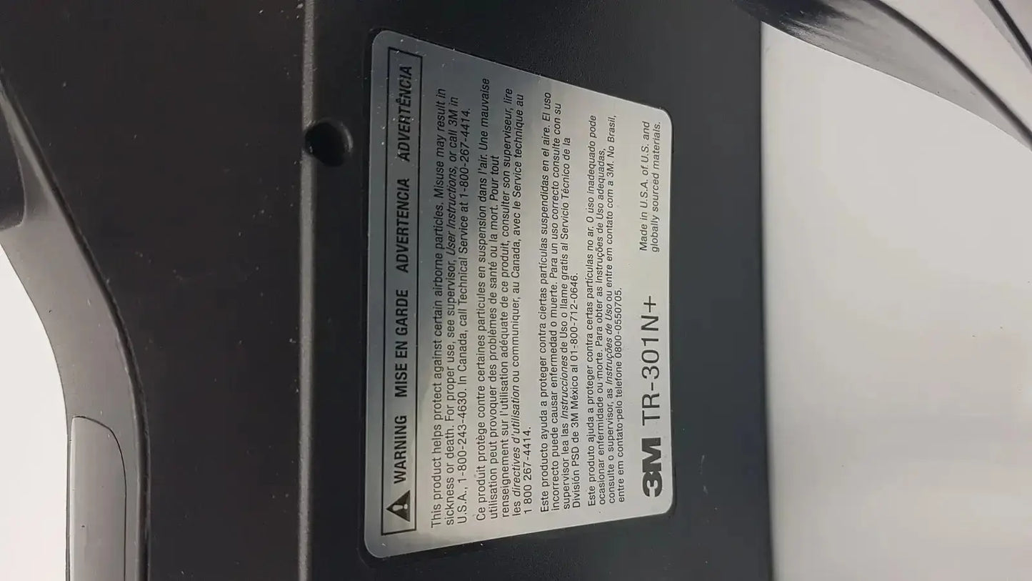 Black 3m versaflo tr-301n+ adhesive tape label with white text and warning symbol for tr-300n+ blower product