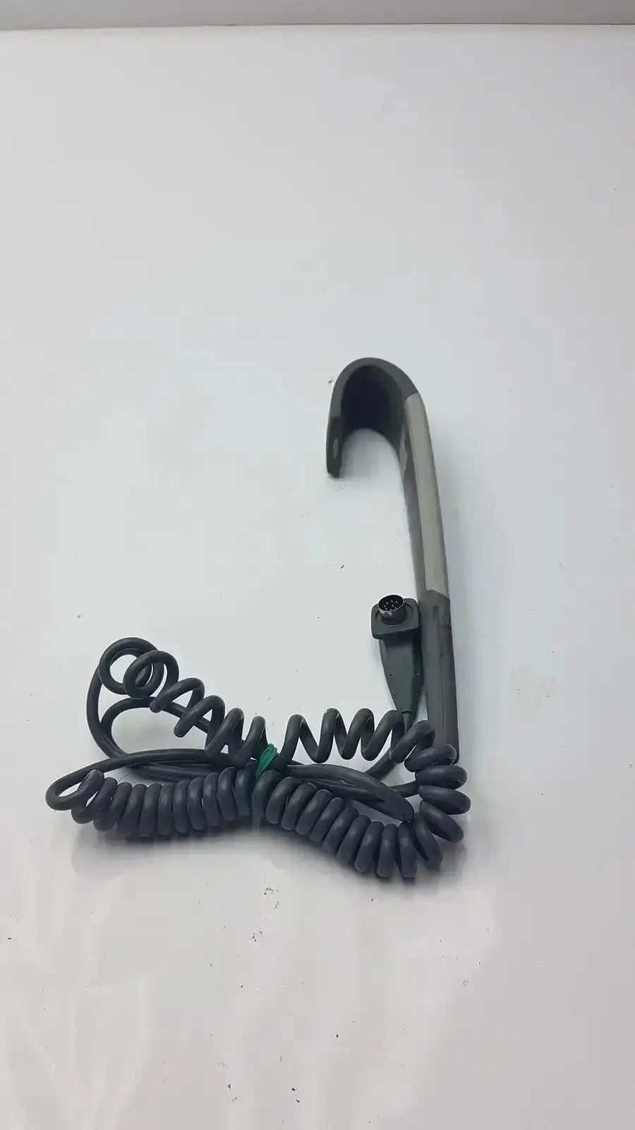 Black coiled cord attached to gray plastic hook with metal clasp for 4-button wired handset arjo lift control panel