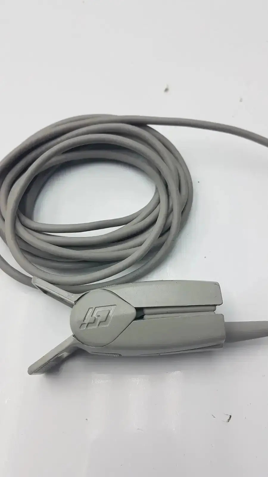 Gray medical-grade 6-pin spo2 finger clip cable with ergonomic adult finger clip featuring embossed logo