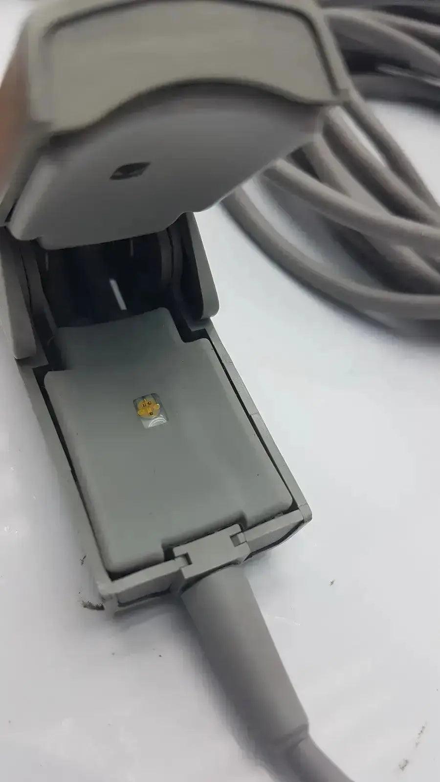 Gray plastic 6-pin spo2 finger clip cable with a small yellow sensor on underside for adult finger clip use