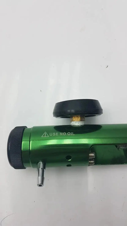 Green metallic medical oxygen cylinder with black caps and use no oil warning label for access point oxygen regulator