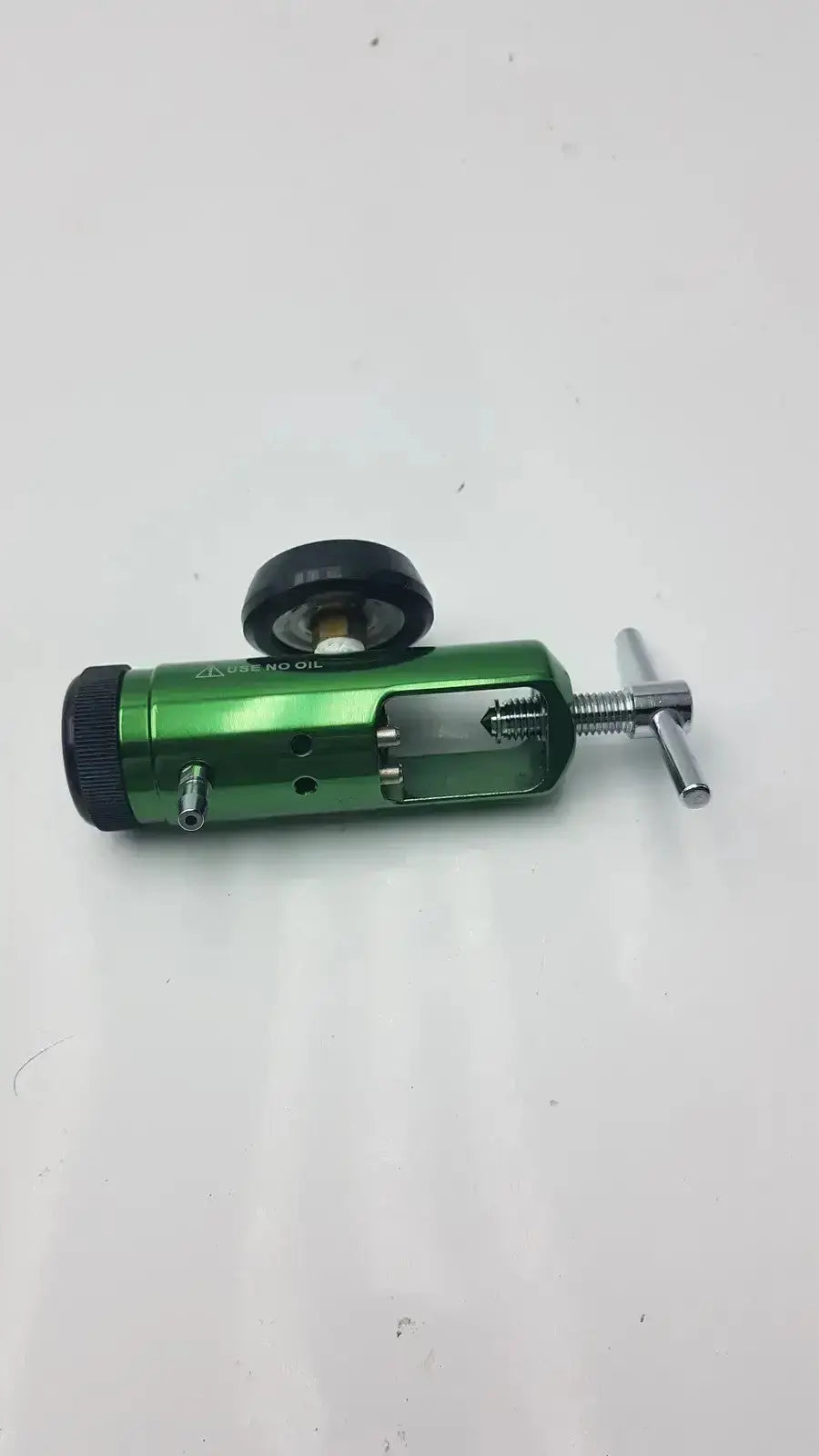 Green metallic medical oxygen regulator with black knob and handle for precise oxygen control by Access Point Medical Oxygen Regulator
