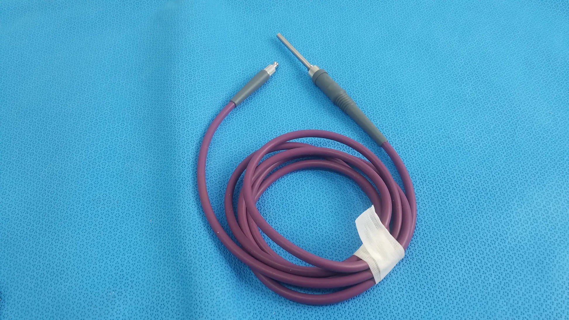 Purple coiled acclarent lgc2 fiber optic light guide cable with gray connectors and metallic tip for medical equipment reuse