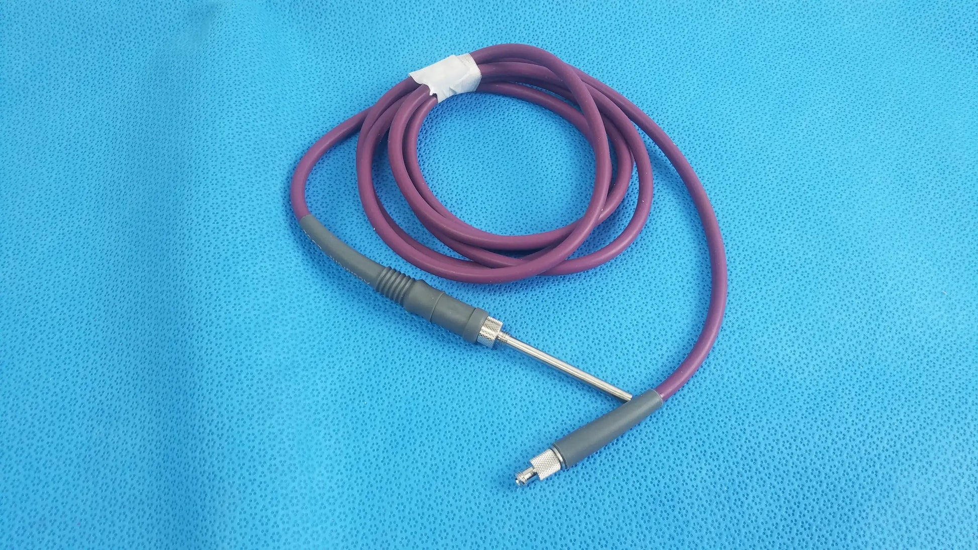 Purple coiled acclarent lgc2 fiber optic light guide cable with gray connectors and metallic probe for medical equipment reuse