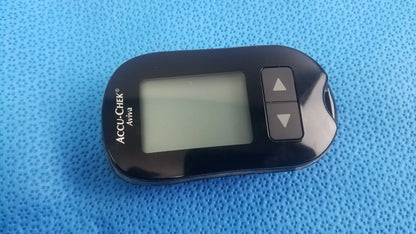 Black accu-chek aviva blood glucose meter with rectangular screen and arrow buttons for medical equipment monitoring