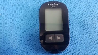 Black Accu Chek Aviva blood glucose meter with rectangular screen and two buttons in medical equipment kit with bag