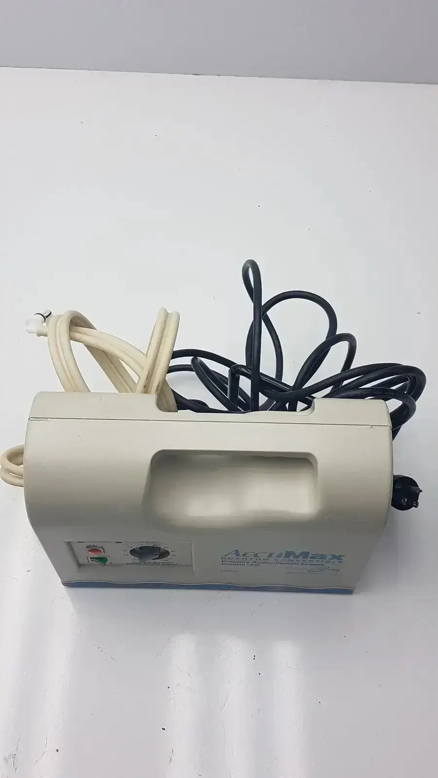 Beige plastic accumax quantum convertible pressure redistribution pump with coiled black and beige power cords