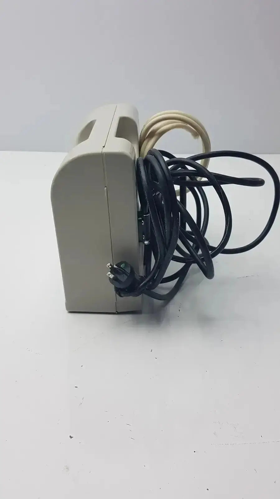Beige plastic accumax quantum convertible pressure redistribution system with coiled black and beige cables visible
