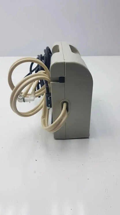 Beige plastic accumax quantum convertible pressure redistribution system showing coiled beige and black cables from side
