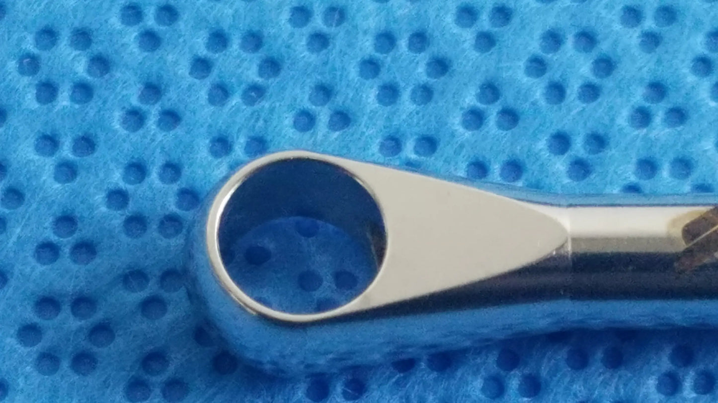 Shiny chrome-plated metal nose hair trimmer with sleek tapered design and rounded handle in dental implant sterilization tray