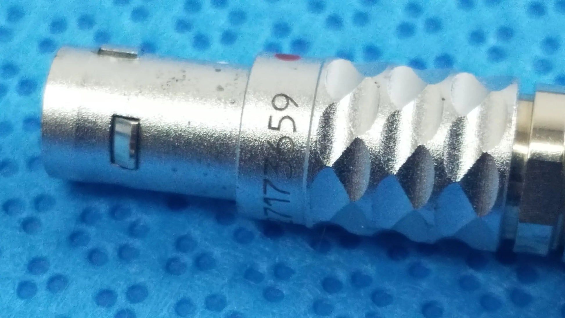 Silver metallic coaxial connector with threaded ridged body and serial number for ace 765-1002 sterilization tray with multigen radiofrequency probe