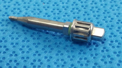 Silver-colored metallic dental implant screw with threaded tip and hexagonal head in ace ophthalmology micro surgery medical equipment tray