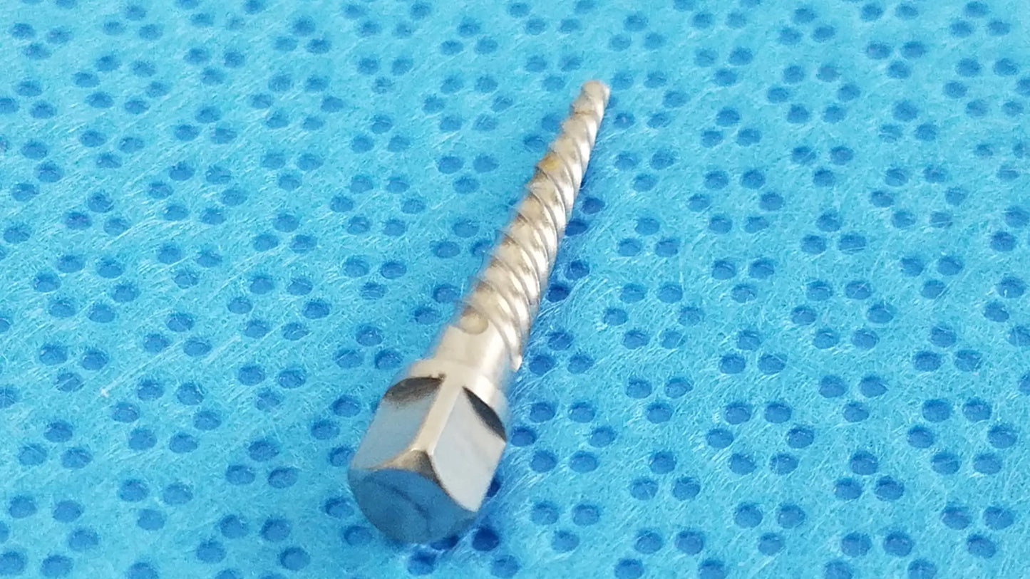 A metallic silver dental implant drill bit with hexagonal drive and spiral cutting edge for reuse medical equipment by smiths medical
