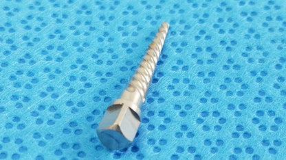 A metallic silver dental implant drill bit with hexagonal drive and spiral cutting edge for reuse medical equipment by smiths medical