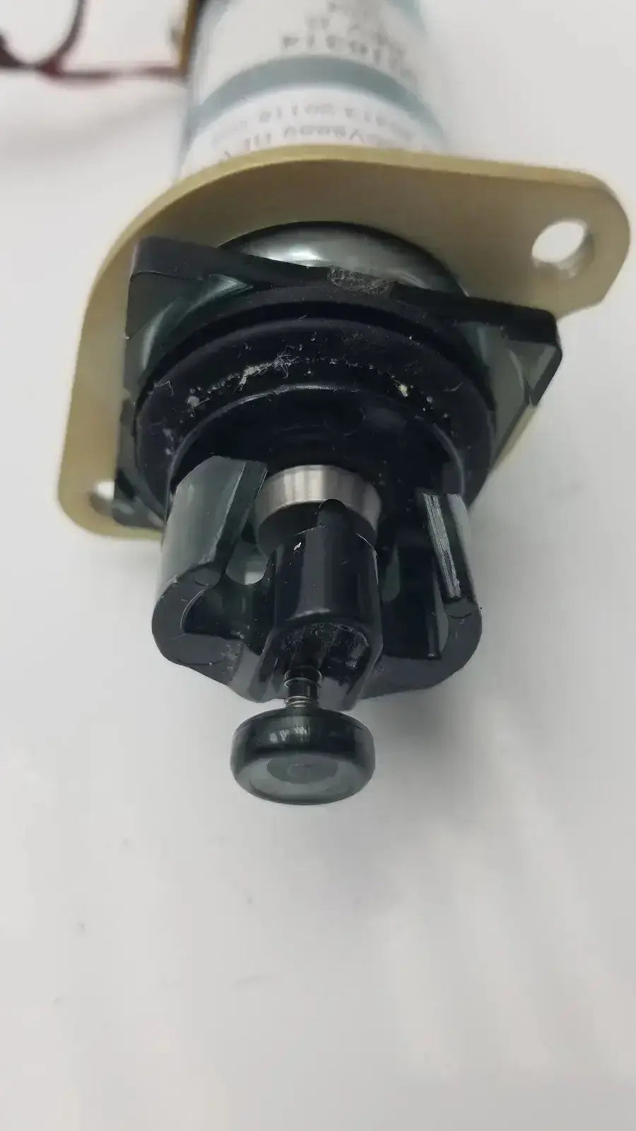 Black plastic and metal valve with a gold mounting bracket acro associates 955v8669 rev a associates 955v8669 rev