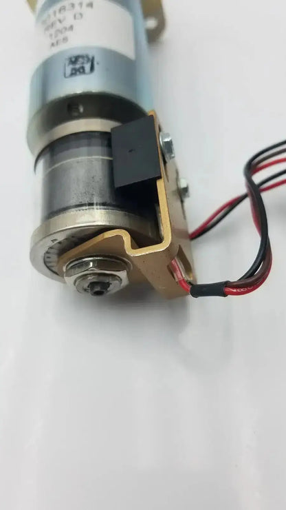 Silver and brass-colored acro associates 955v8669 rev a valve electric motor with black wiring and 12v dc label