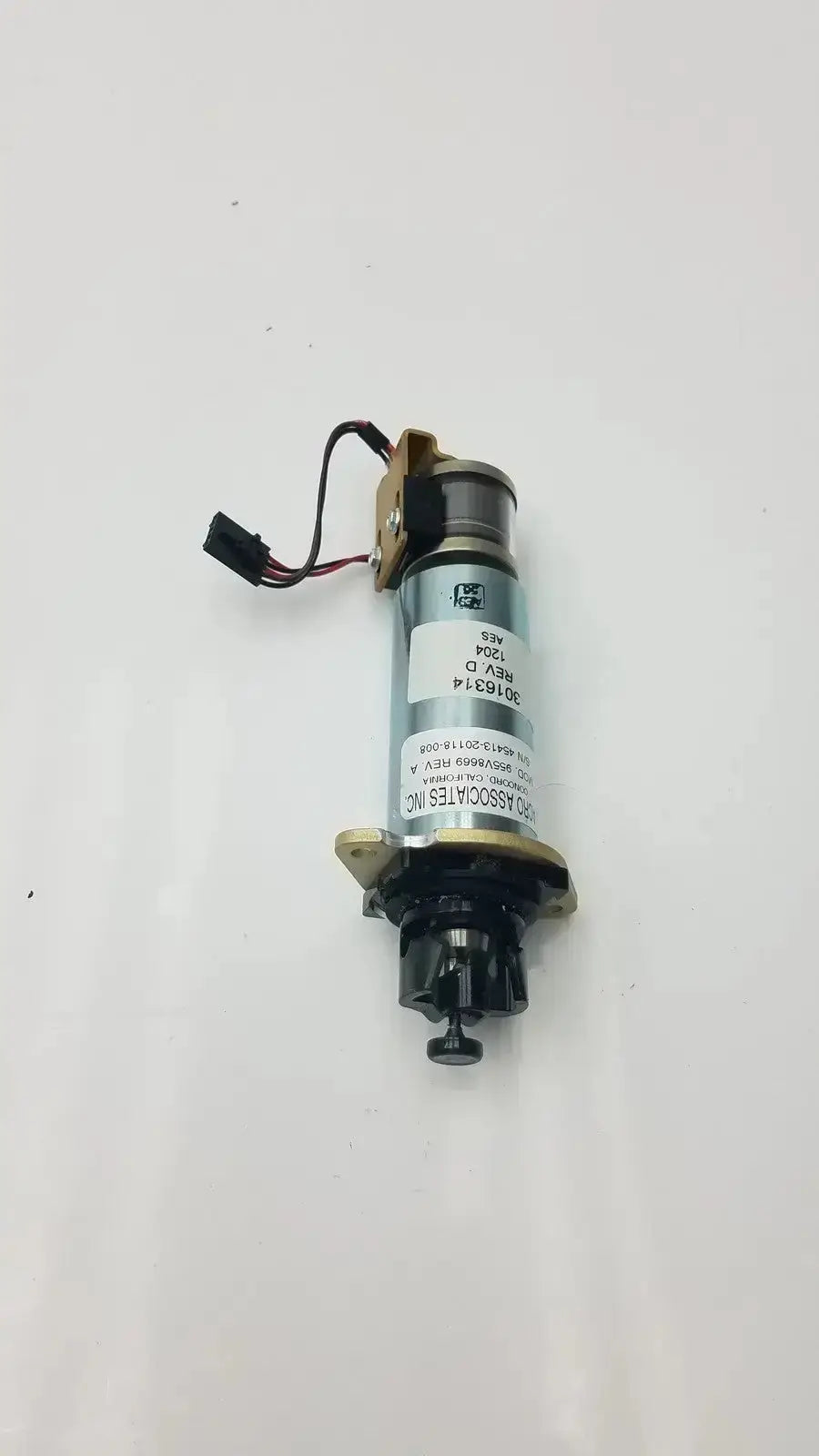 A cylindrical metal actuator with black electrical connector and brass mounting brackets for acro associates 955v8669 rev valve