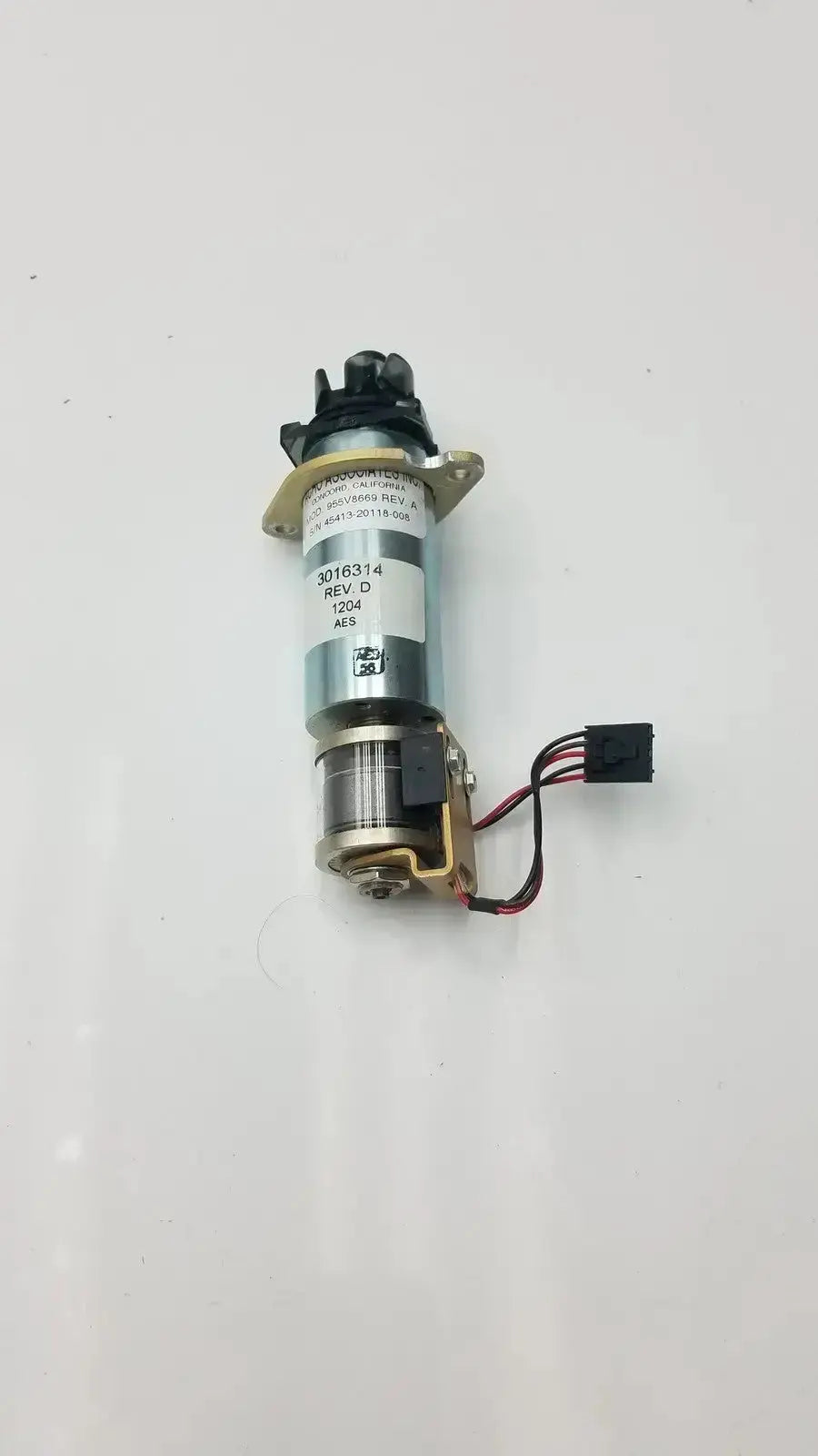 Metallic cylindrical motor with black plastic components and multi-colored wire harness in acro associates 955v8669 rev valve
