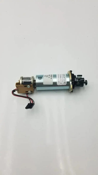 Silver cylindrical motor with black and gold components and label featuring technical specifications of acro associates 955v8669 rev a valve