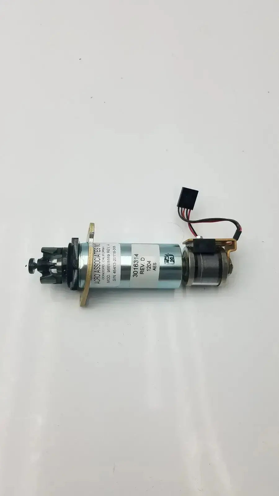 Silver cylindrical motor with black wiring and engraved labeling for acro associates 955v8669 rev a valve