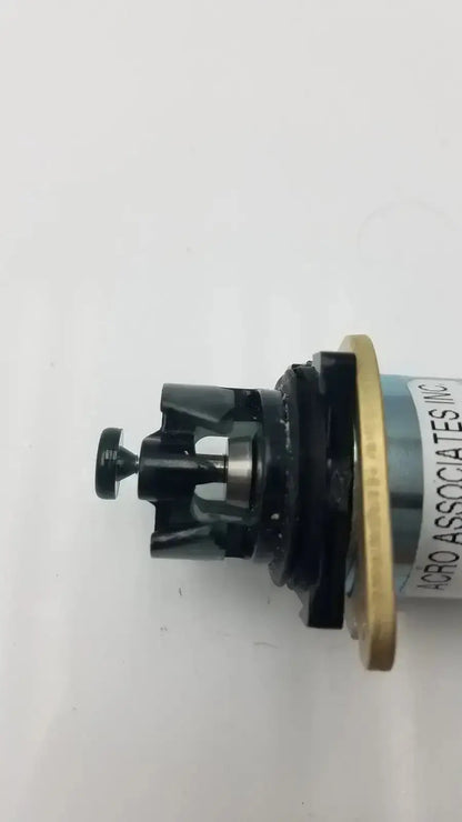 Black plastic gear assembly with brass ring and metallic shaft from acro associates 955v8669 rev valve product
