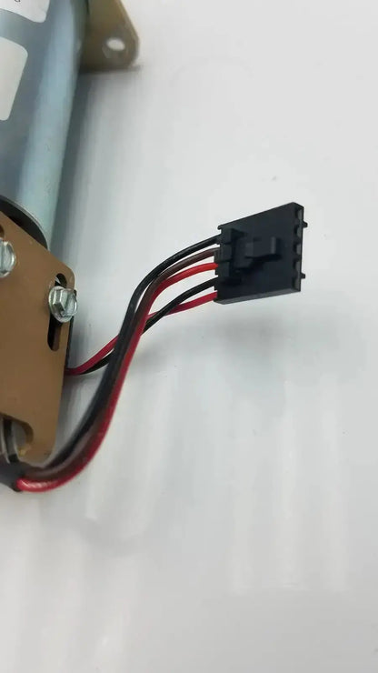 Silver cylindrical motor with black and red wiring connected to a black plastic connector in acro associates 955v8669 rev valve